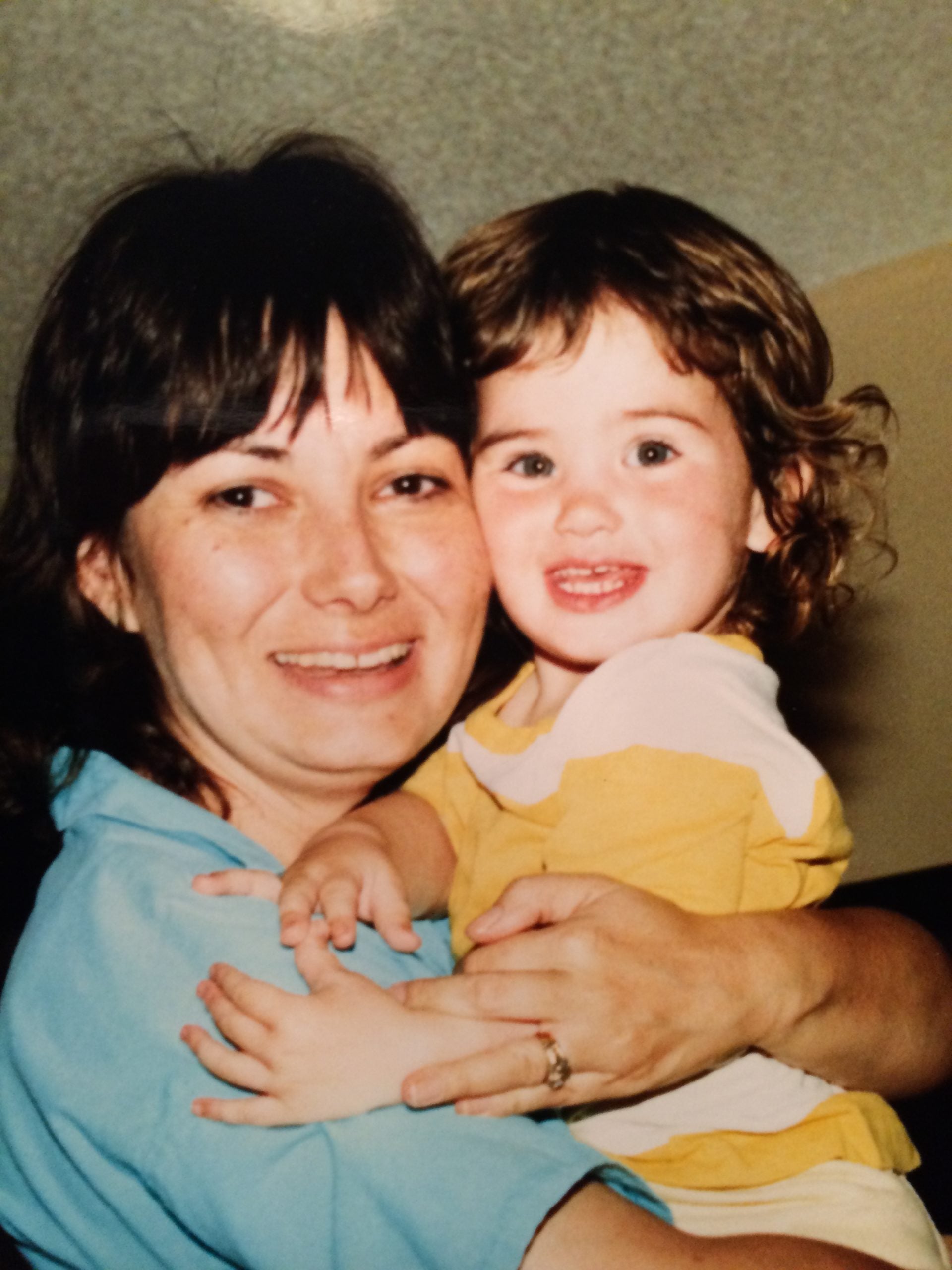 Author as a toddler being held by her mother